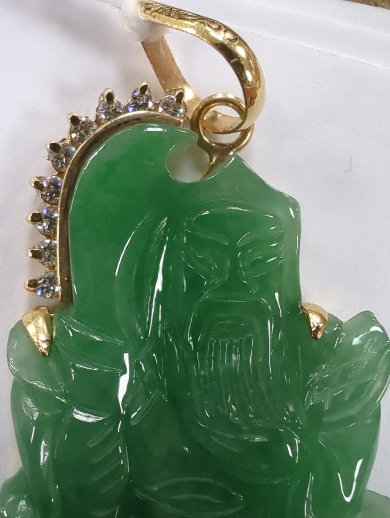 A modern 18k and diamond chip mounted jadeite pendant, carved as an immortal, 40mm, gross weight 9.1 grams.